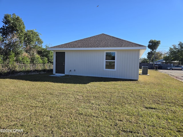 view of home's exterior with a yard and central AC