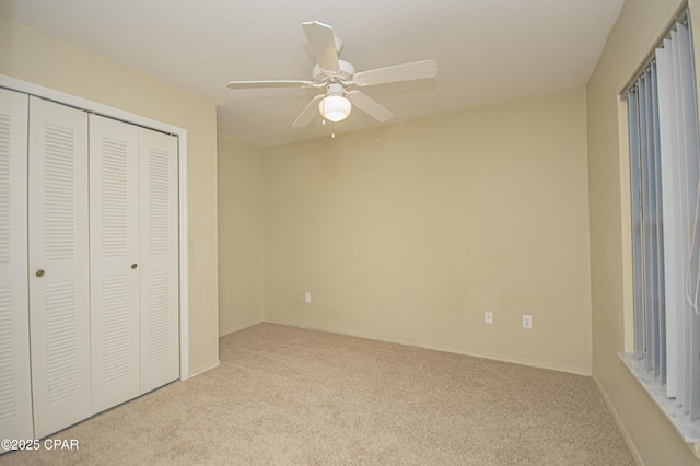 unfurnished bedroom with carpet flooring, a closet, and ceiling fan