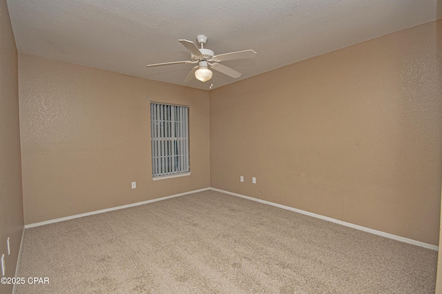 spare room featuring a textured ceiling, carpet flooring, baseboards, and a ceiling fan