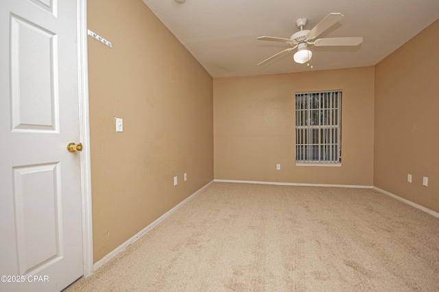 unfurnished room with baseboards, a ceiling fan, and carpet