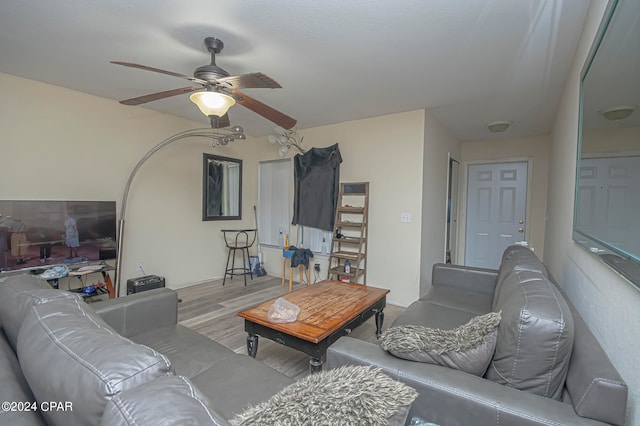 living room featuring light wood-type flooring and ceiling fan