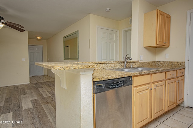 kitchen featuring dishwasher, a sink, a ceiling fan, a peninsula, and light brown cabinetry