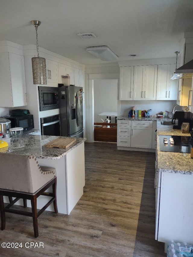 kitchen featuring black appliances, kitchen peninsula, decorative light fixtures, dark hardwood / wood-style flooring, and white cabinetry