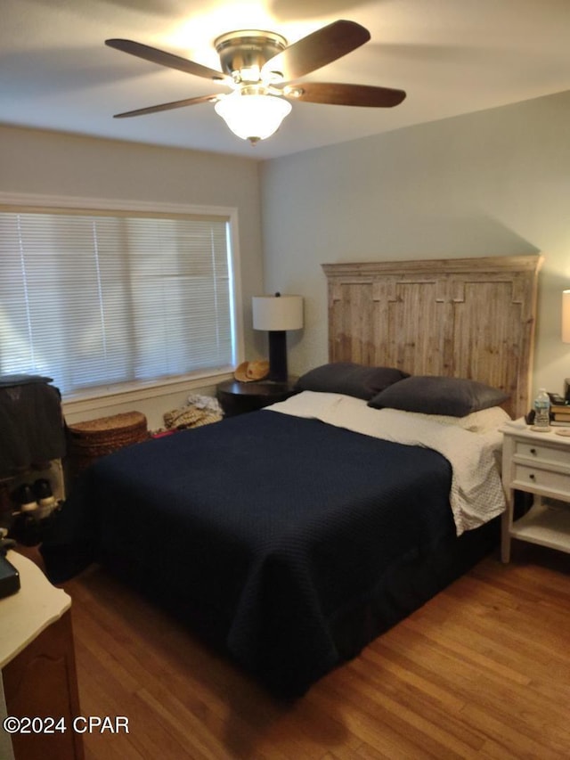 bedroom with hardwood / wood-style floors and ceiling fan