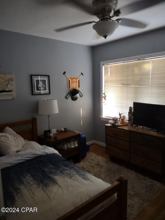 bedroom with hardwood / wood-style floors and ceiling fan