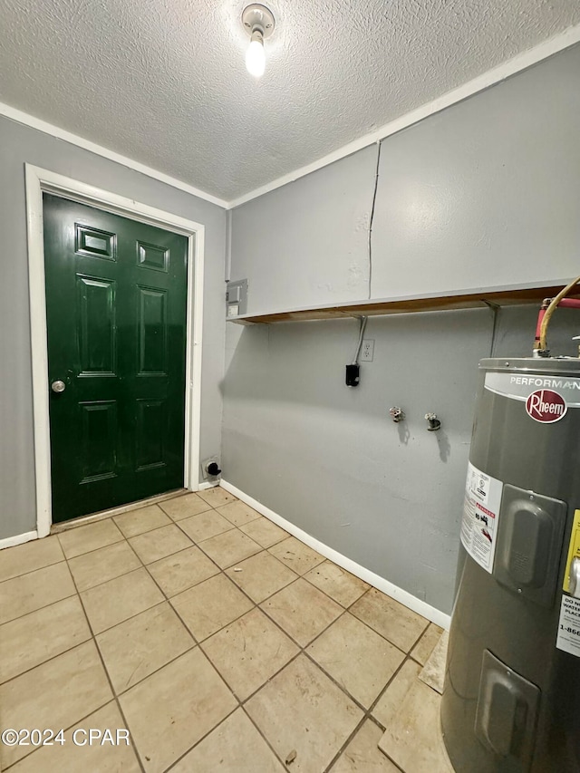 laundry room with crown molding, a textured ceiling, light tile patterned flooring, and water heater