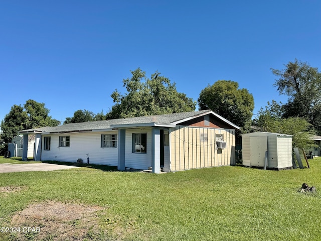 view of front of property with a shed and a front yard