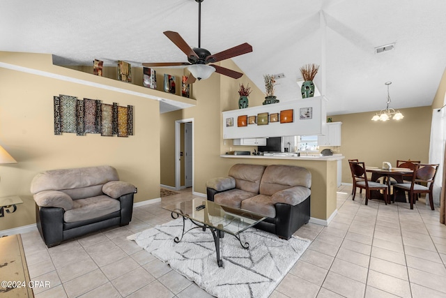 living room with ceiling fan with notable chandelier, light tile patterned floors, and high vaulted ceiling