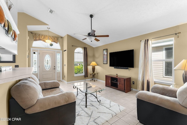 living room with a textured ceiling, ceiling fan, lofted ceiling, and light tile patterned flooring