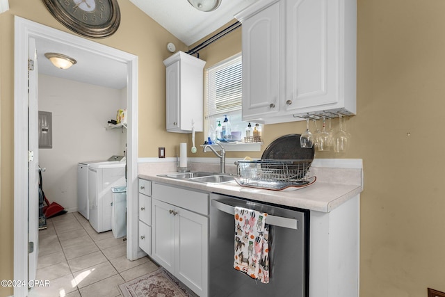 kitchen with sink, light tile patterned floors, stainless steel dishwasher, white cabinets, and washer and dryer