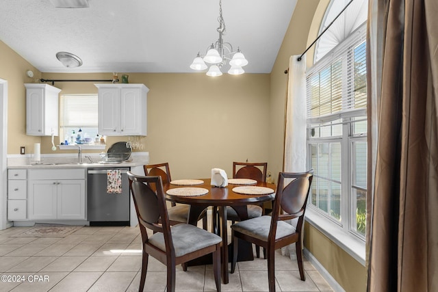 dining area with vaulted ceiling, a wealth of natural light, a notable chandelier, and light tile patterned flooring