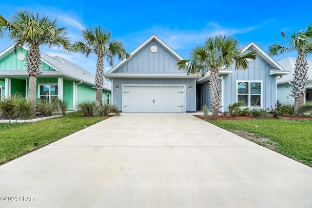 view of front of house with a garage and a front lawn