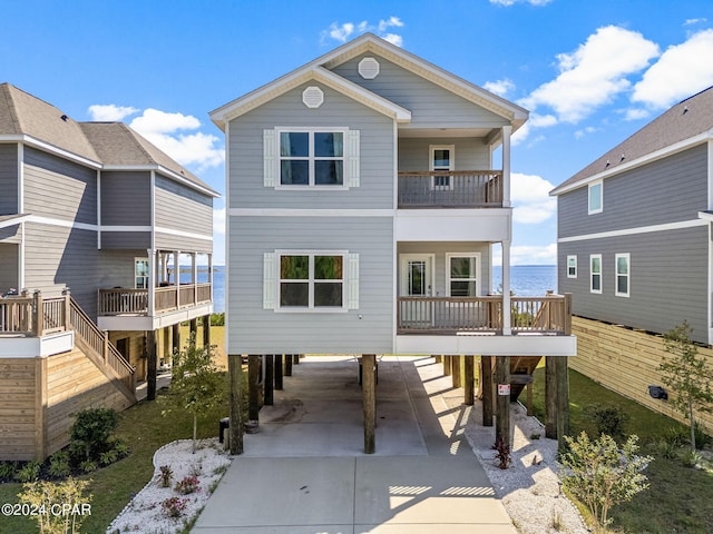 rear view of property featuring a water view and a carport