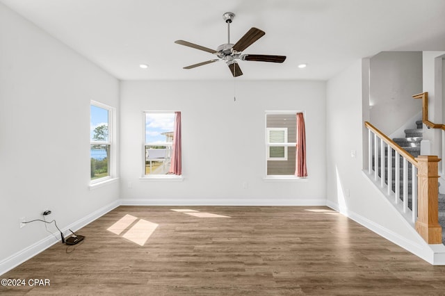 empty room with hardwood / wood-style flooring and ceiling fan