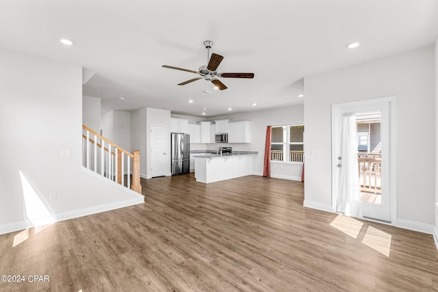 unfurnished living room with light hardwood / wood-style flooring and ceiling fan