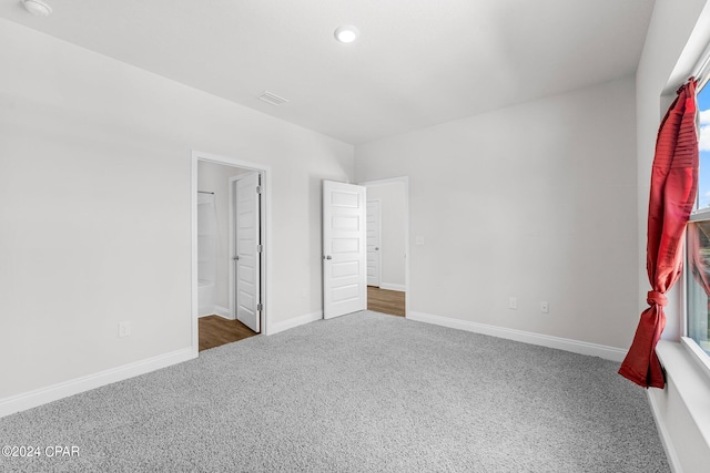 unfurnished bedroom featuring dark colored carpet