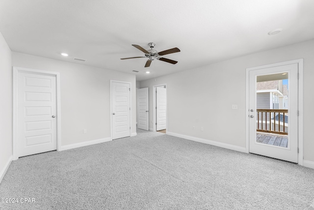 carpeted empty room featuring ceiling fan