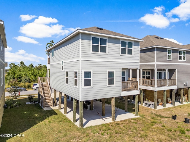 rear view of house featuring a yard and a patio area