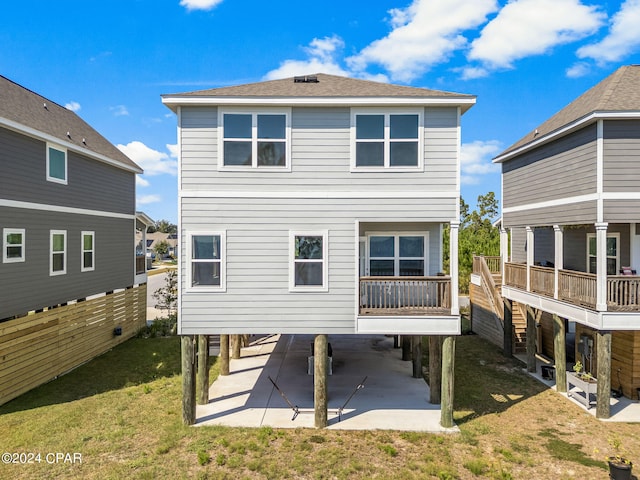 back of property with a patio and a lawn