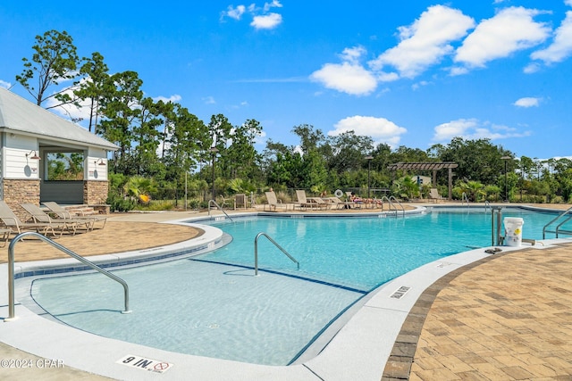 view of swimming pool with a patio area