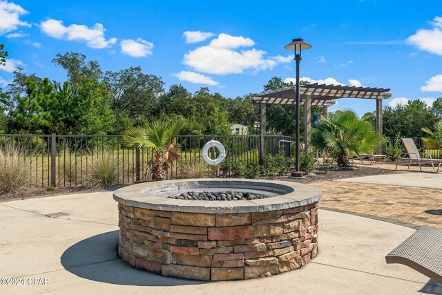 view of patio / terrace with a pergola and an outdoor fire pit