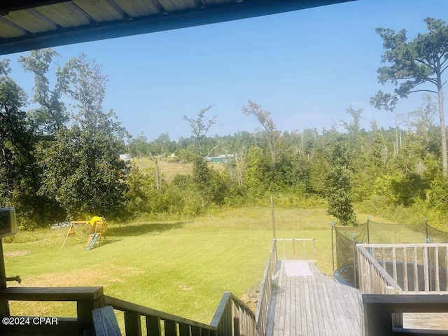 view of yard featuring a playground and a deck