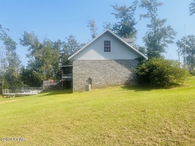 view of side of property with a lawn