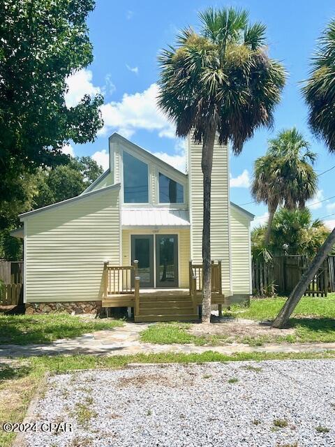 rear view of property featuring fence