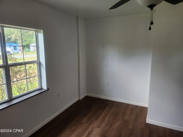 unfurnished room featuring dark wood-type flooring and ceiling fan