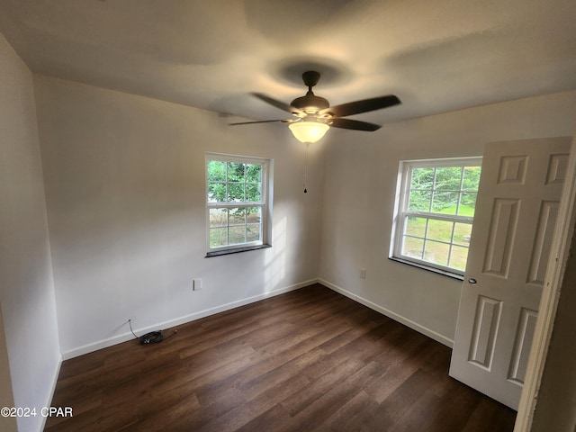 empty room featuring dark hardwood / wood-style floors and ceiling fan