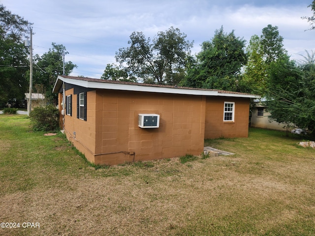 view of outdoor structure featuring a lawn