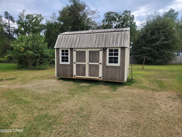 view of outdoor structure with a lawn