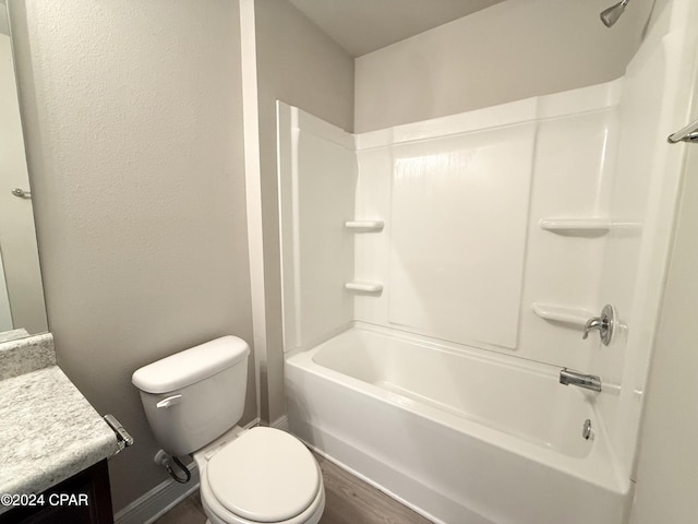 full bathroom featuring hardwood / wood-style floors, vanity, toilet, and shower / washtub combination