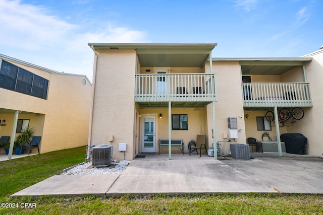 rear view of house featuring central AC unit and a patio area