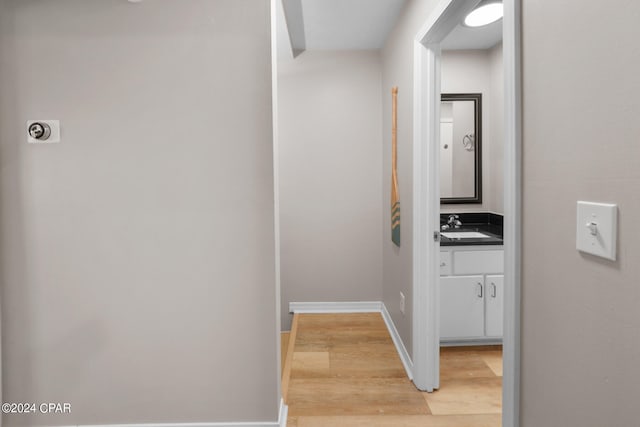 hall featuring sink and light wood-type flooring