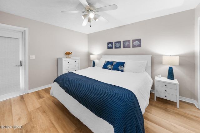 bedroom with ceiling fan and light hardwood / wood-style flooring