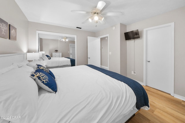 bedroom with ceiling fan, a closet, and wood-type flooring