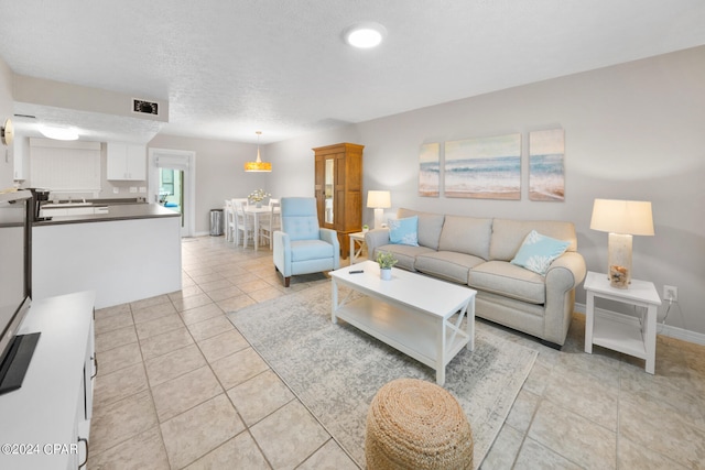 living room with light tile patterned floors and a textured ceiling