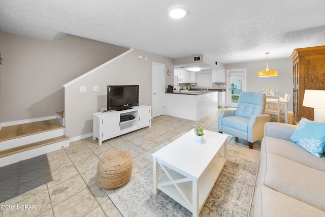 living room featuring light tile patterned floors and a textured ceiling