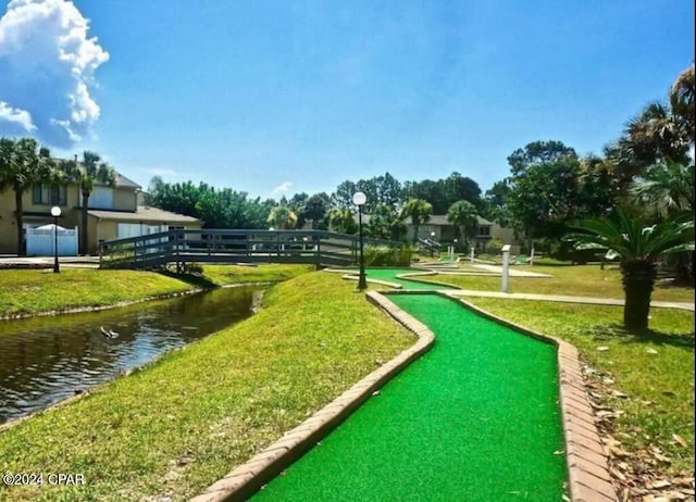 view of home's community with a yard and a water view