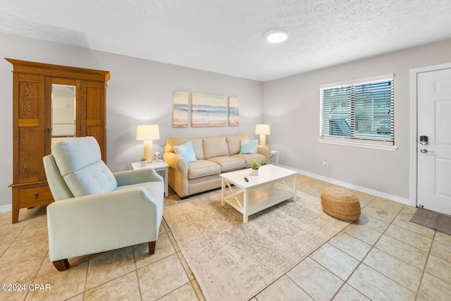 living room with light tile patterned floors and a textured ceiling