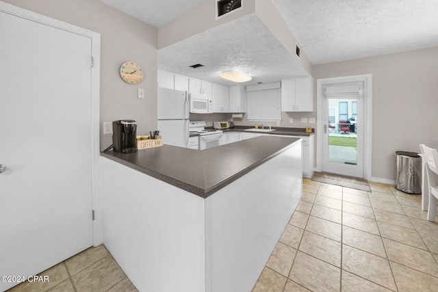 kitchen featuring kitchen peninsula, white cabinetry, sink, and white appliances