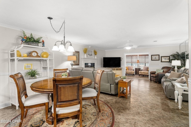 dining area featuring crown molding and ceiling fan with notable chandelier