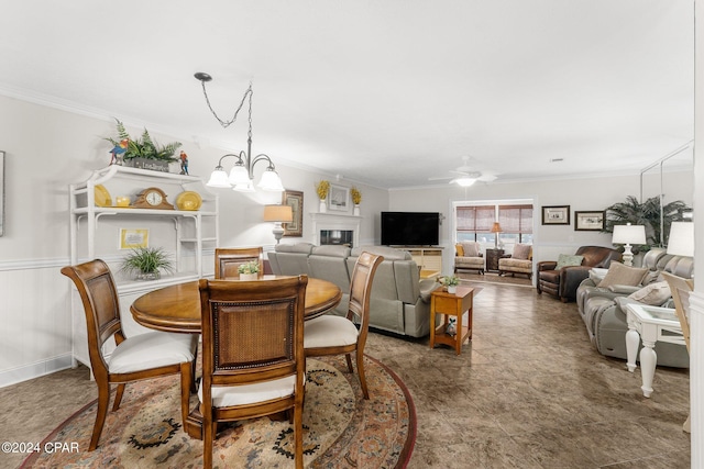 dining space featuring crown molding and ceiling fan with notable chandelier