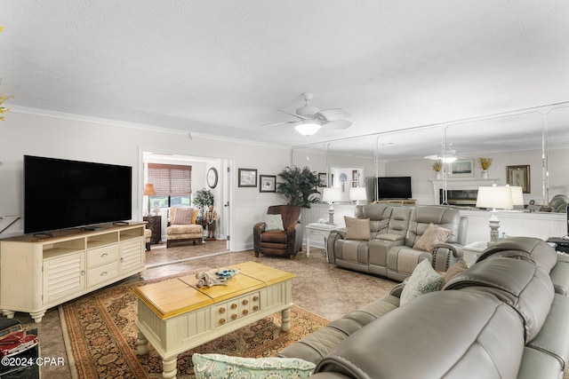 living room with ornamental molding, a textured ceiling, light tile patterned floors, and ceiling fan