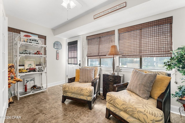 sitting room with tile patterned floors and ceiling fan