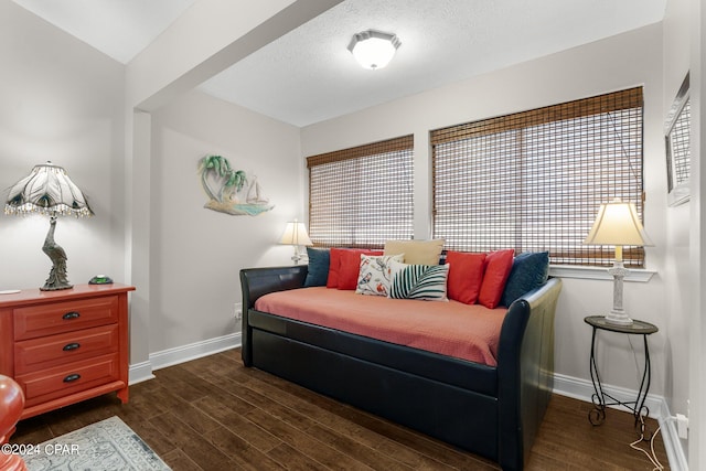 bedroom featuring dark wood-type flooring and multiple windows