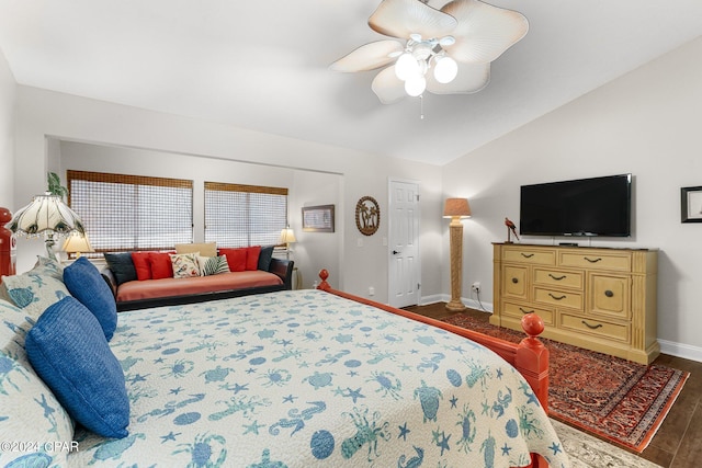 bedroom with vaulted ceiling, dark hardwood / wood-style floors, and ceiling fan