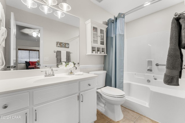 full bathroom with vanity, shower / bath combo with shower curtain, toilet, and tile patterned flooring