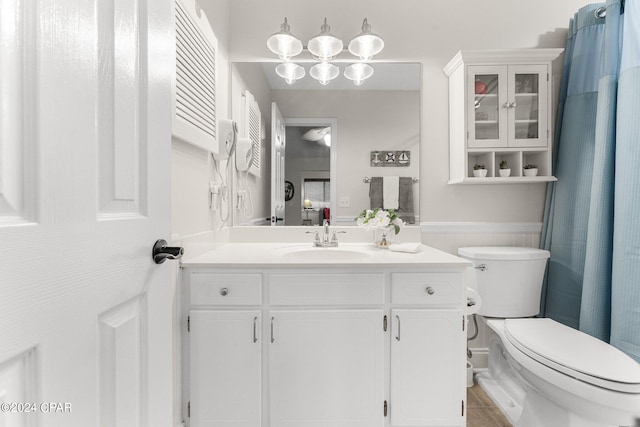 bathroom featuring vanity, toilet, and tile patterned flooring